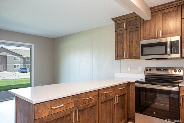 1153 Straight Creek Dr Unit F102, Dillon, CO 80435 - kitchen with appliances with stainless steel finishes and a peninsula