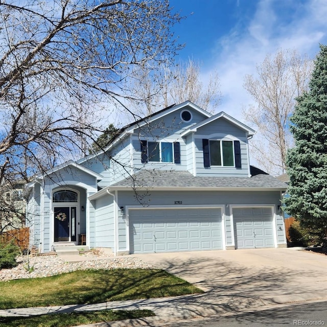 view of front of home with an attached garage, driveway, and roof with shingles