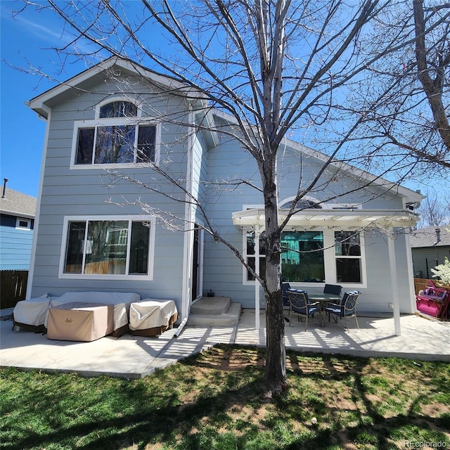 back of property featuring a patio area and fence