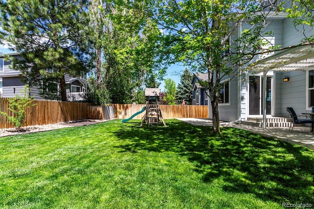 view of yard with a playground and a patio area