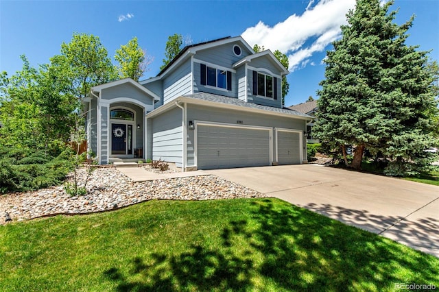 traditional-style house with a garage, driveway, and a front lawn