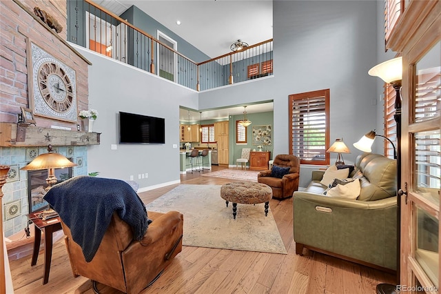 living area with baseboards and wood finished floors