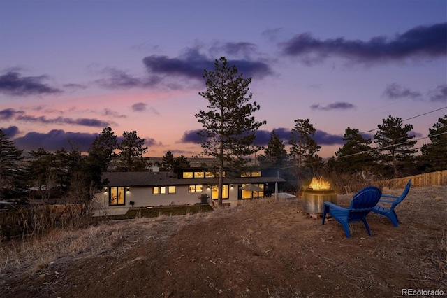 view of back house at dusk