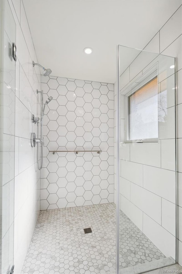 bathroom with a shower with shower door