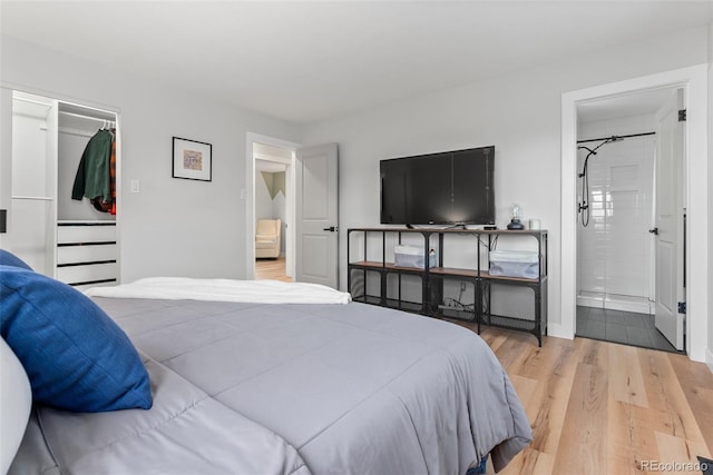 bedroom featuring hardwood / wood-style floors and ensuite bath