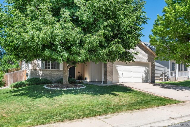 5332 S Lisbon Way, Centennial, CO 80015 - view of property hidden behind natural elements featuring a garage, brick siding, and concrete driveway
