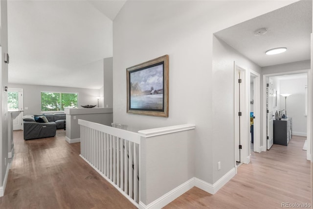 5332 S Lisbon Way, Centennial, CO 80015 - hallway with light wood-type flooring, an upstairs landing, and baseboards