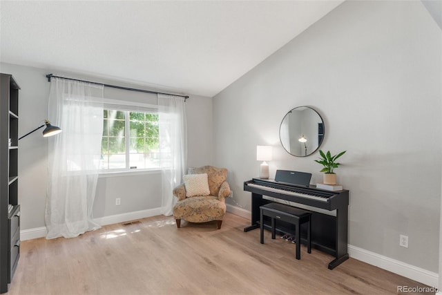 5332 S Lisbon Way, Centennial, CO 80015 - living area with light wood-type flooring, vaulted ceiling, and baseboards