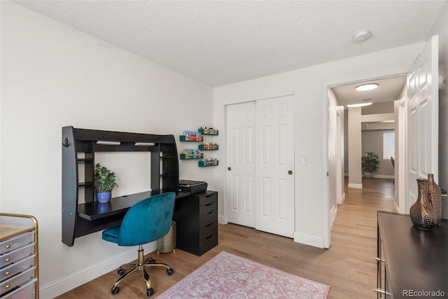 5332 S Lisbon Way, Centennial, CO 80015 - office space with light wood-style flooring, baseboards, and a textured ceiling
