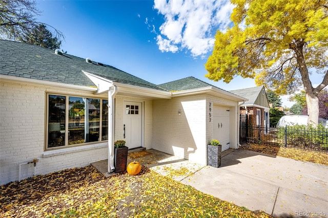 view of exterior entry with a patio and a garage