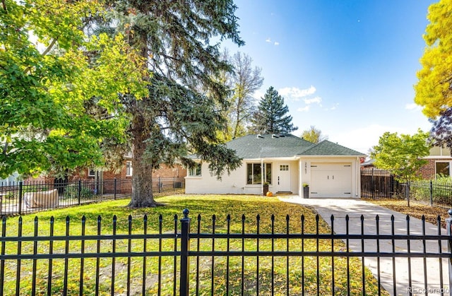 view of front of home featuring a front yard and a garage