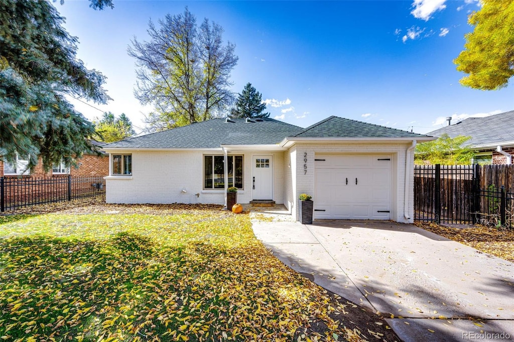 ranch-style house with a front lawn and a garage