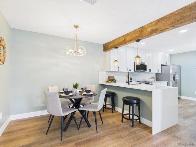 7205 S Gaylord St Unit G, Centennial, CO 80122 - dining area with a chandelier, light wood-type flooring, baseboards, beamed ceiling, and recessed lighting