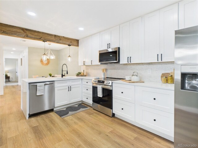 7205 S Gaylord St Unit G, Centennial, CO 80122 - kitchen with stainless steel appliances, a sink, a peninsula, light wood-style flooring, and recessed lighting
