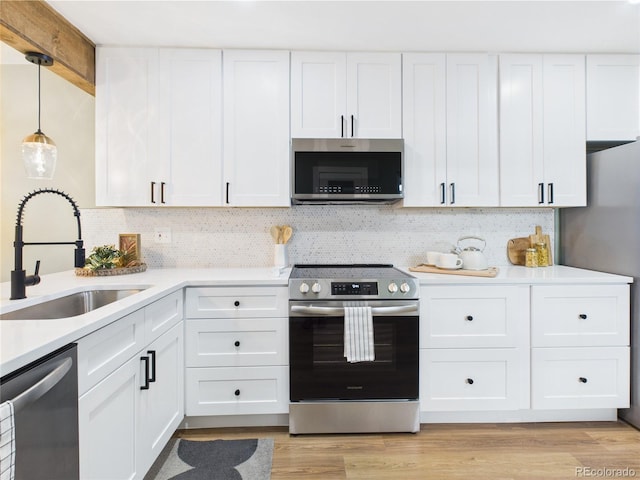 7205 S Gaylord St Unit G, Centennial, CO 80122 - kitchen with stainless steel appliances, a sink, and white cabinets