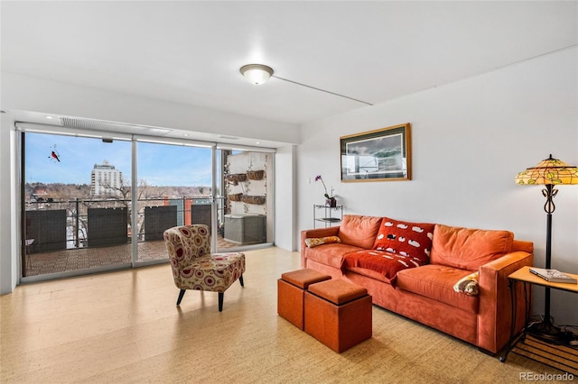 living room featuring a wall of windows