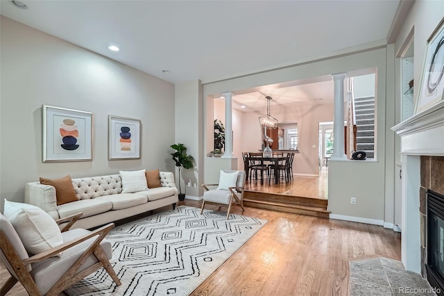222 S Monroe St, Denver, CO 80209 - living room with ornate columns, wood finished floors, baseboards, a tile fireplace, and recessed lighting