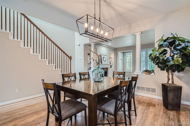 222 S Monroe St, Denver, CO 80209 - dining room featuring decorative columns, light wood finished floors, baseboards, and stairs