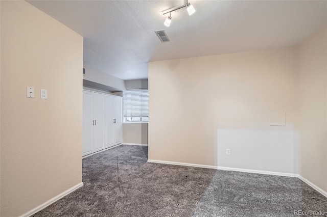 222 S Monroe St, Denver, CO 80209 - carpeted empty room with baseboards and a textured ceiling