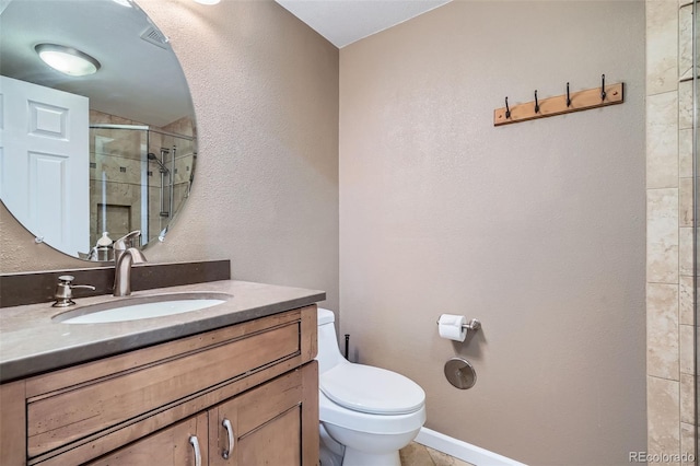 222 S Monroe St, Denver, CO 80209 - full bathroom with toilet, vanity, a tile shower, a textured wall, and baseboards