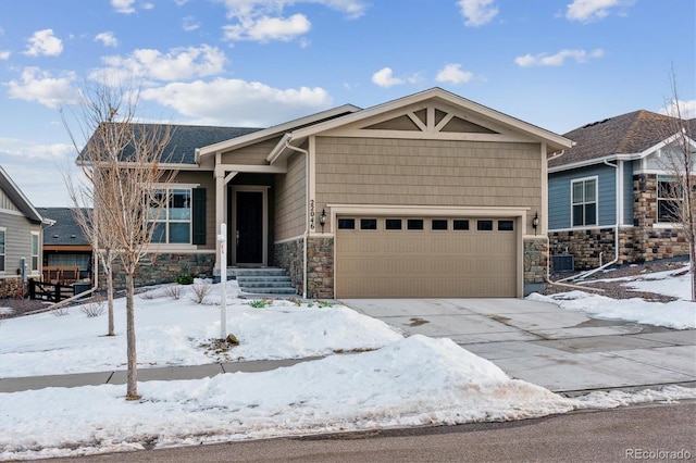 craftsman inspired home with a garage and central air condition unit