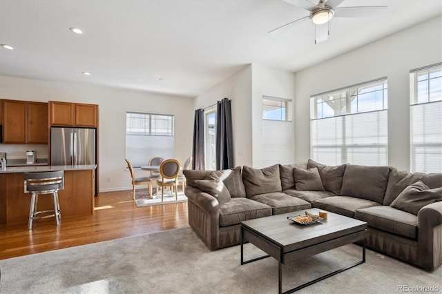 carpeted living room featuring ceiling fan