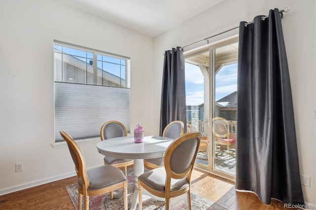 dining room with a wealth of natural light and hardwood / wood-style floors