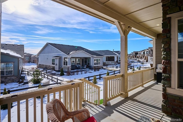 snow covered deck with covered porch