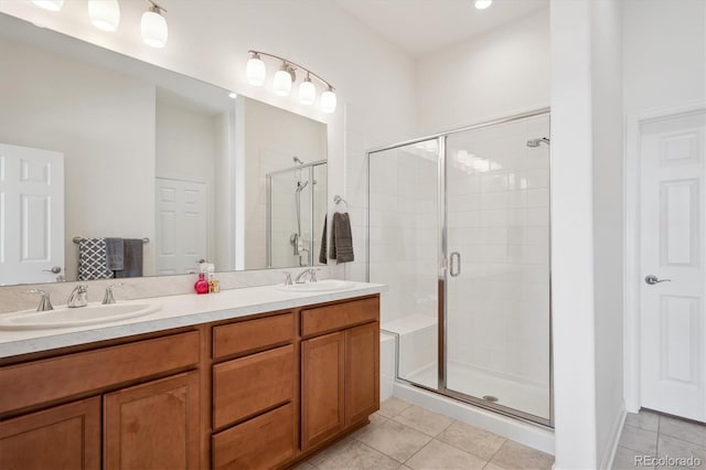 bathroom featuring tile patterned flooring, vanity, and a shower with door