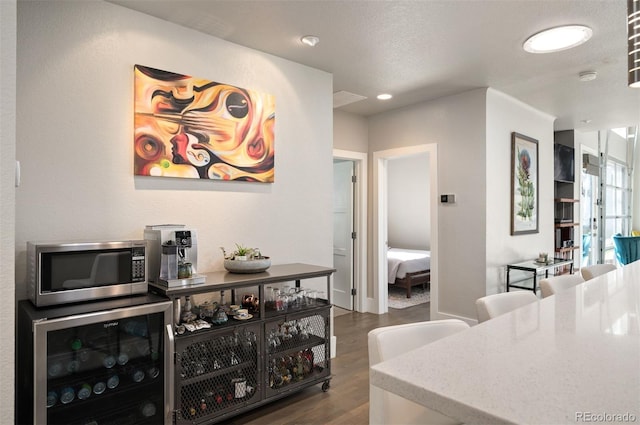 dining room featuring wine cooler and dark wood-style floors