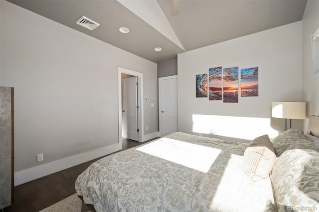 bedroom featuring visible vents, dark wood-type flooring, ceiling fan, baseboards, and lofted ceiling