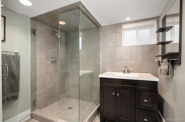 bathroom with a stall shower and vanity