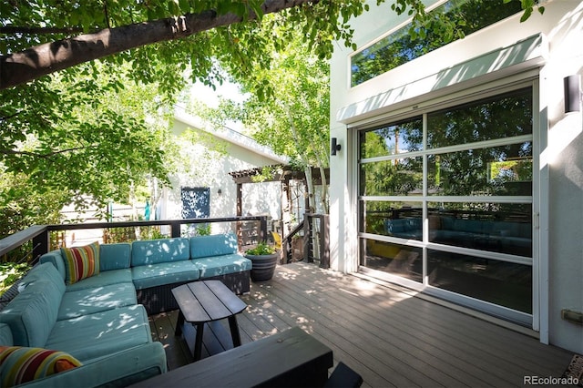 wooden deck featuring an outdoor hangout area and fence