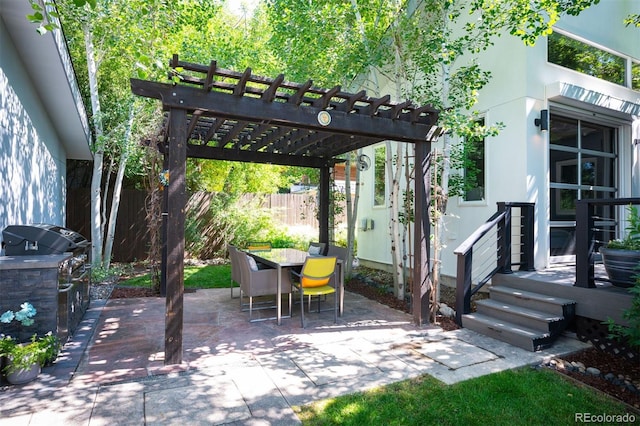 view of patio with area for grilling, a pergola, outdoor dining area, and fence