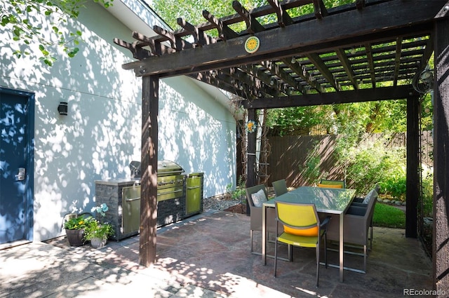 view of patio featuring outdoor dining area, an outdoor kitchen, a pergola, and fence