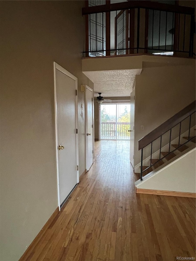 hall featuring hardwood / wood-style floors and a textured ceiling