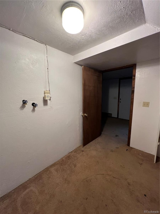 basement with carpet flooring and a textured ceiling