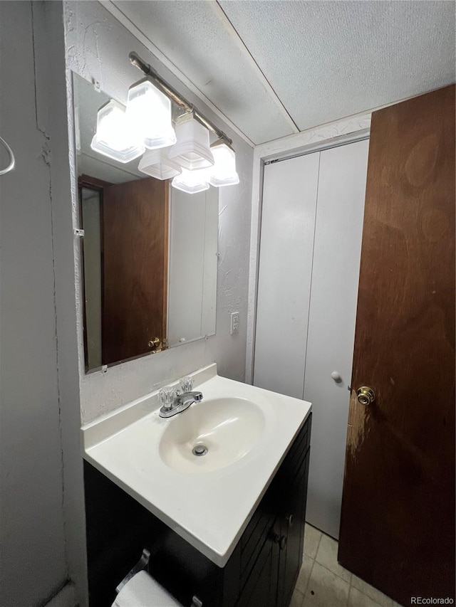 bathroom featuring tile patterned flooring and vanity