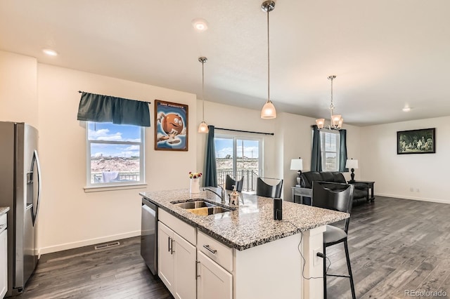2417 Mountain Sky Dr, Fort Lupton, CO 80621 - kitchen with a sink, appliances with stainless steel finishes, dark wood-style flooring, light stone countertops, and baseboards