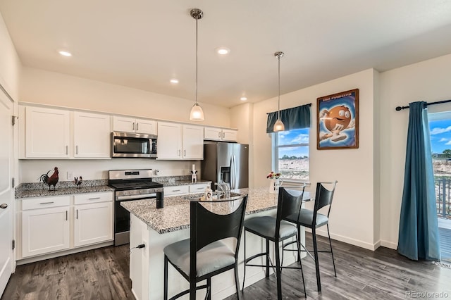 2417 Mountain Sky Dr, Fort Lupton, CO 80621 - kitchen featuring stainless steel appliances, dark wood finished floors, white cabinets, light stone countertops, and recessed lighting