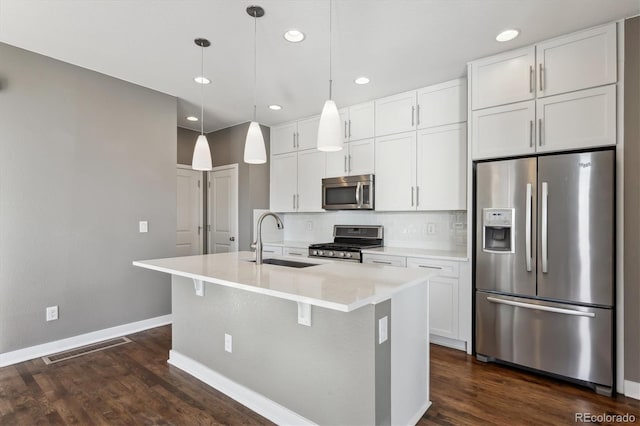 kitchen with appliances with stainless steel finishes, sink, and white cabinets