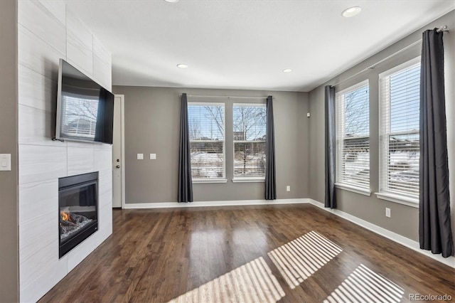 unfurnished living room with dark hardwood / wood-style flooring and a fireplace