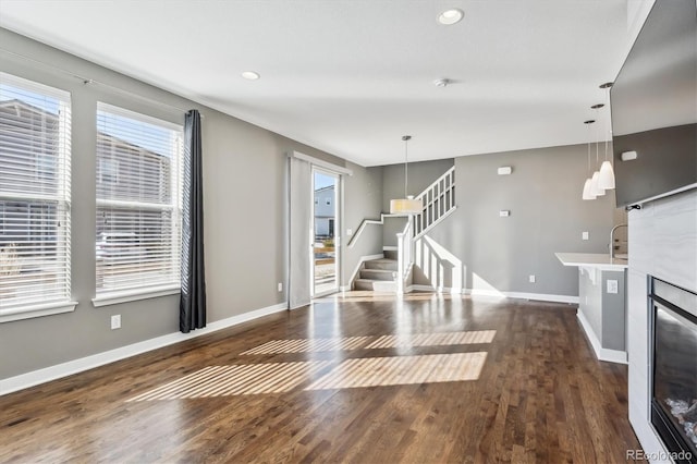 unfurnished living room featuring dark hardwood / wood-style flooring