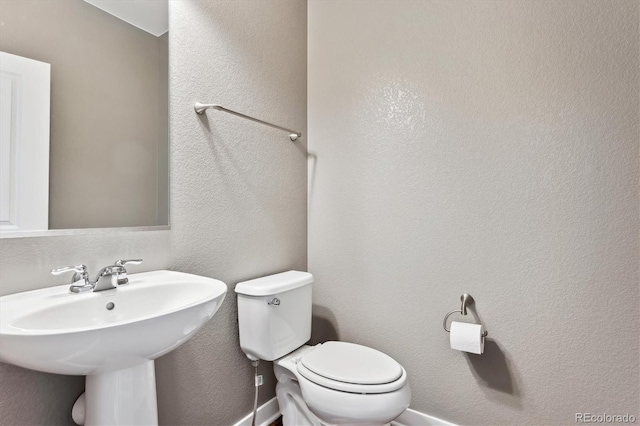 bathroom with toilet and sink