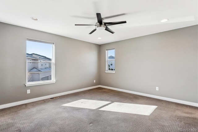 empty room with ceiling fan and carpet floors