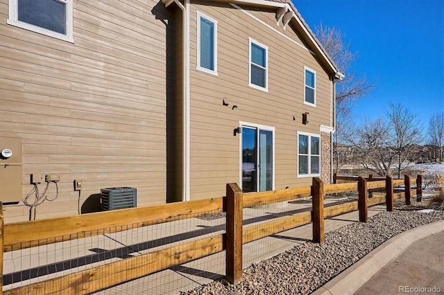 view of side of home featuring central AC