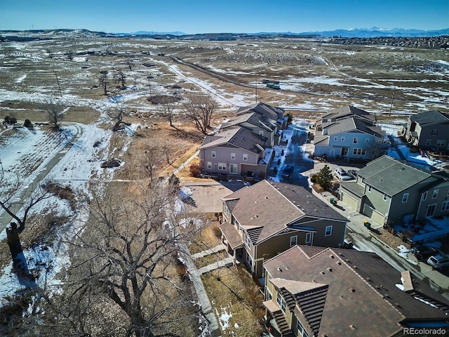 snowy aerial view with a mountain view