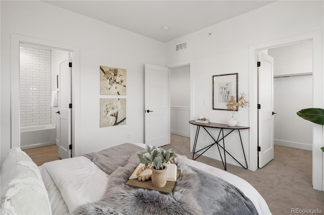 4507-4513 Tabor St, Wheat Ridge, CO 80033 - bedroom featuring a walk in closet, ensuite bath, light colored carpet, and baseboards