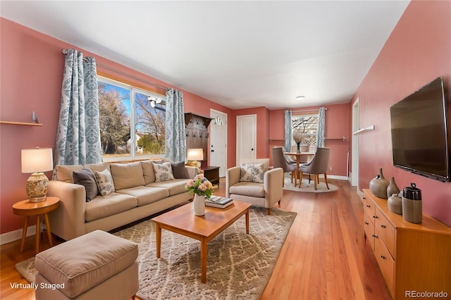 living room with light wood-style flooring and baseboards