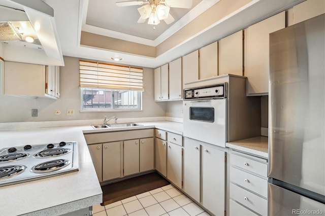 kitchen featuring ceiling fan, sink, white appliances, light tile floors, and range hood